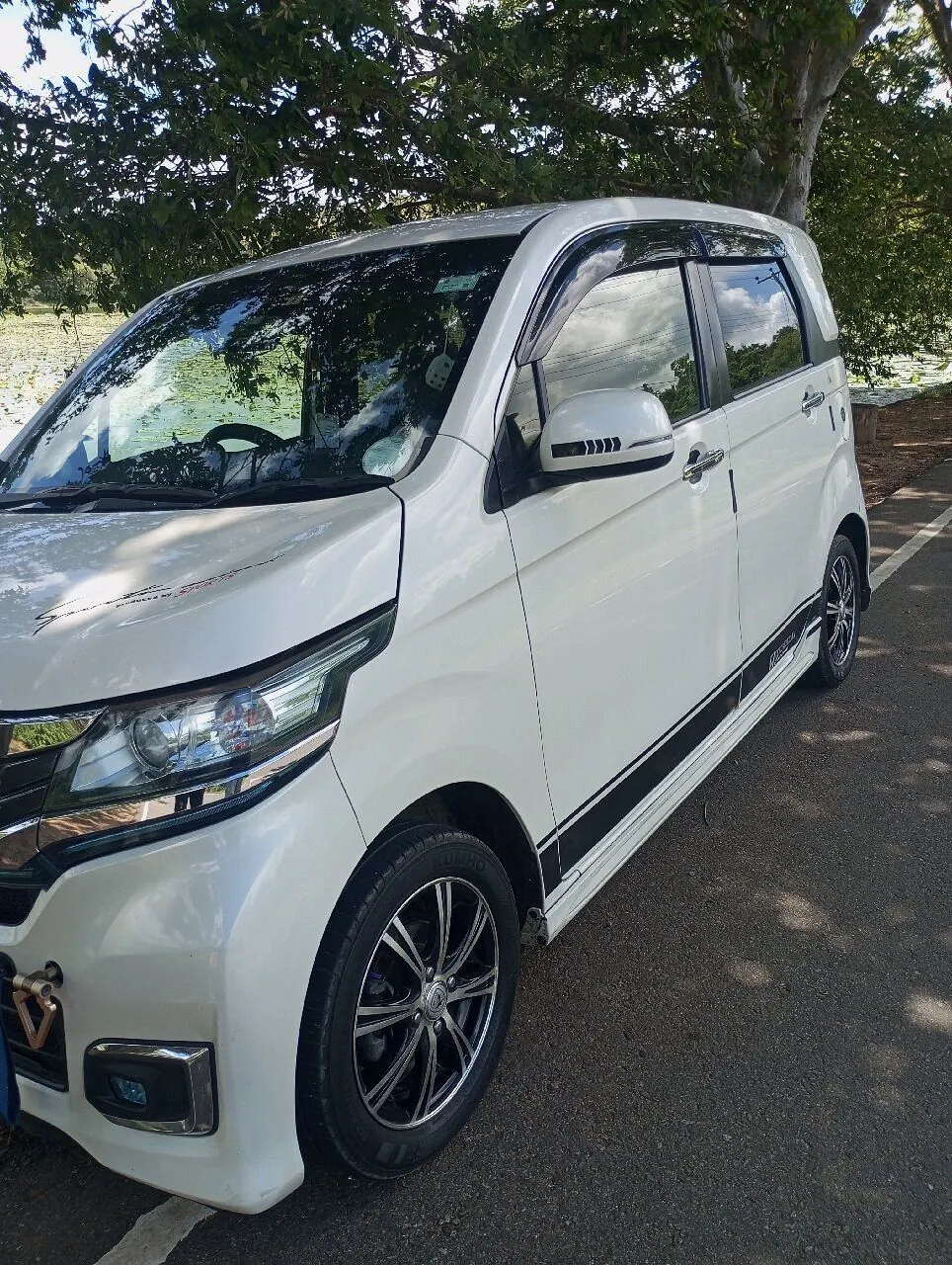 Dinu's white Honda on a shaded road