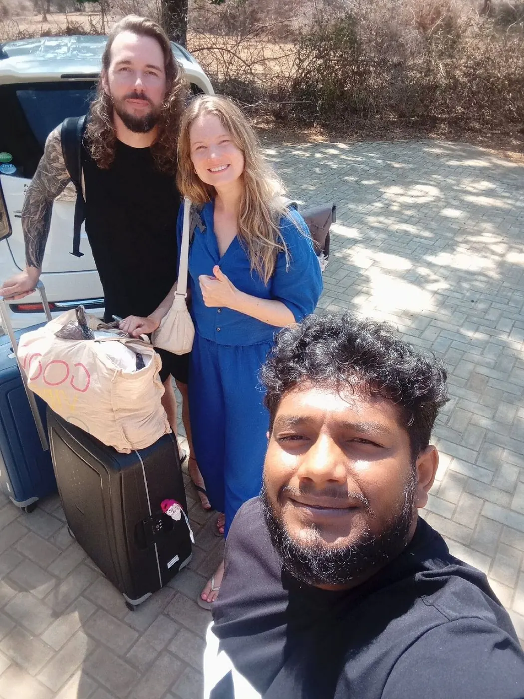 Dinu with two guests and their luggage on arrival day